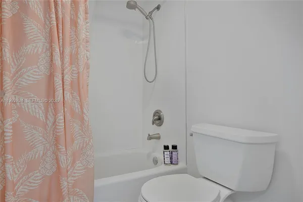 a bathroom with a toilet and shower