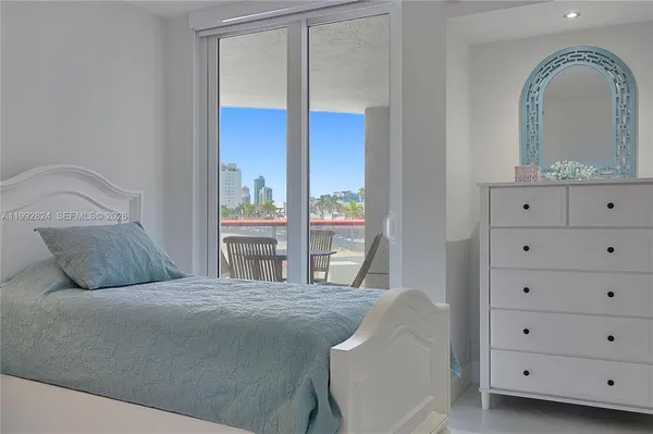 a bedroom with a bed and a mirror