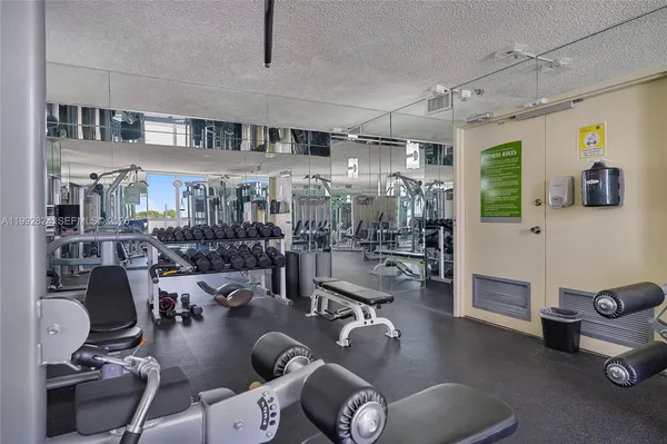a gym room with lots of gym equipment