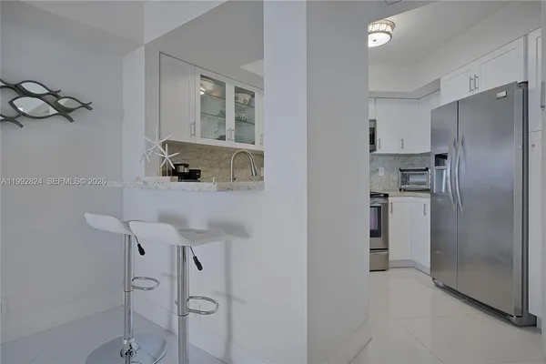 a kitchen with stainless steel appliances a refrigerator and a sink