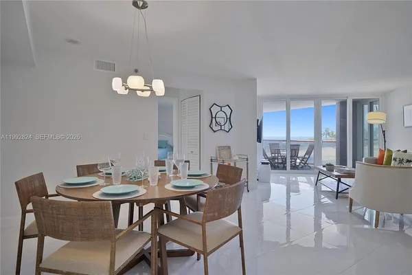 a view of a dining room with furniture and chandelier