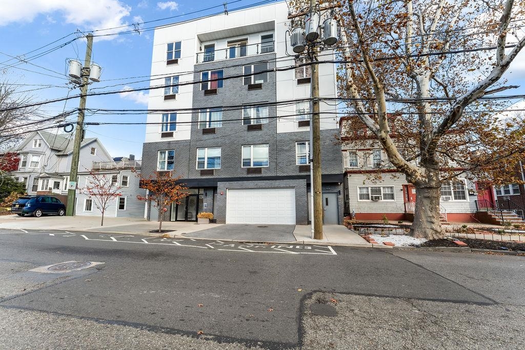 43-45 West 32nd Street, Unit 503 Bayonne, NJ 07002 - Photo 16 of 19 a tall building on a street corner