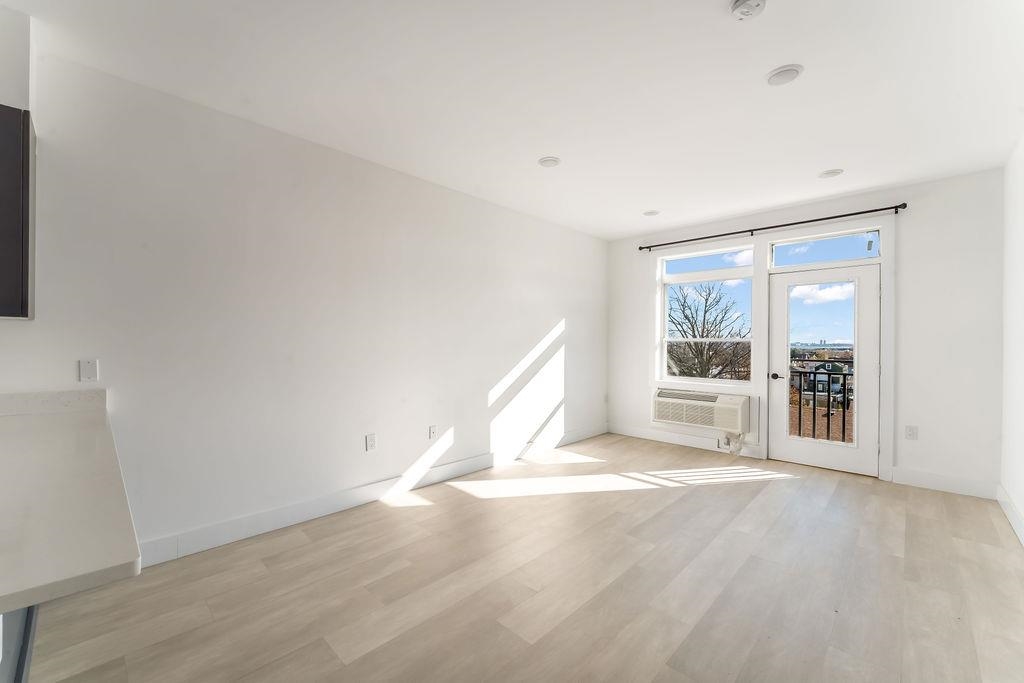 43-45 West 32nd Street, Unit 503 Bayonne, NJ 07002 - Photo 5 of 19 an empty room with windows