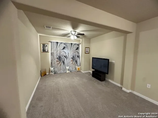 en empty room with furniture and flat screen tv