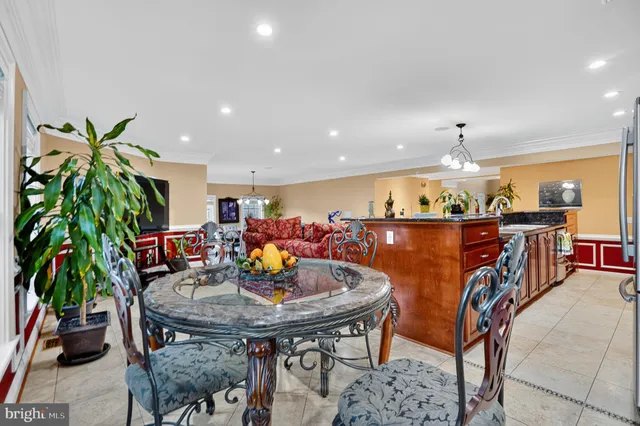 a view of a dining room with furniture and a potted plant