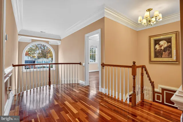 wooden floor with a chandelier
