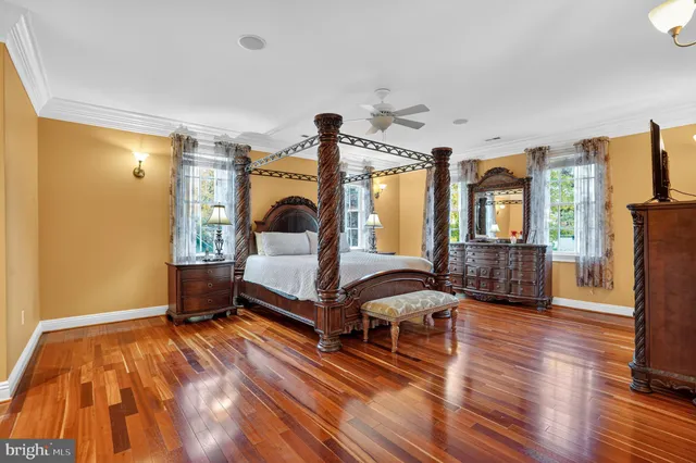 a bedroom with furniture and a large window