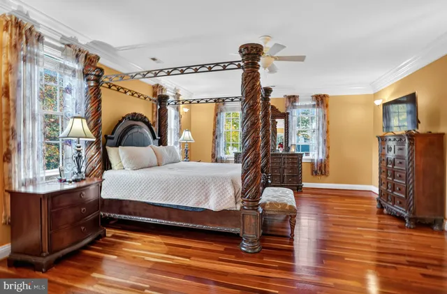 a bedroom with furniture and wooden floor