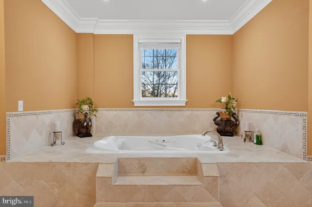 a bathroom with a granite countertop sink and a bathtub