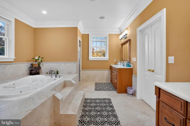 a bathroom with a tub sink and mirror