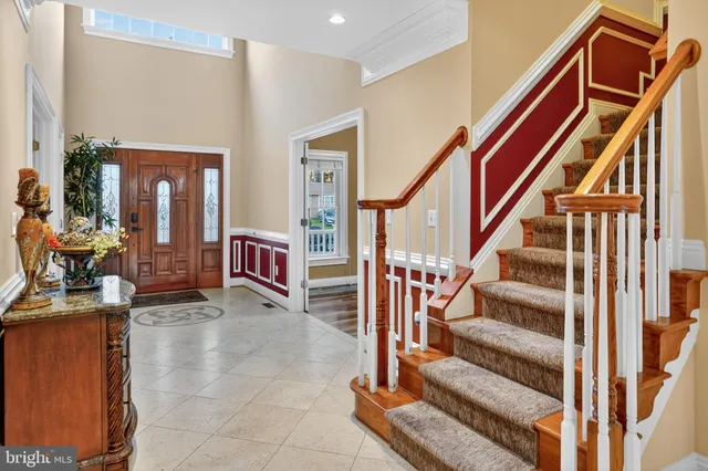 a view of staircase with lots of frames and couches