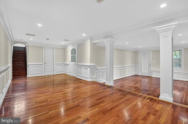 a view of empty room with wooden floor
