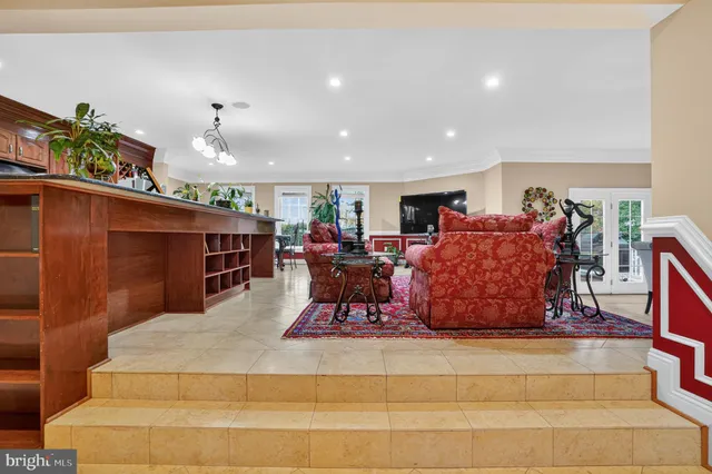 a living room with furniture a rug and white walls
