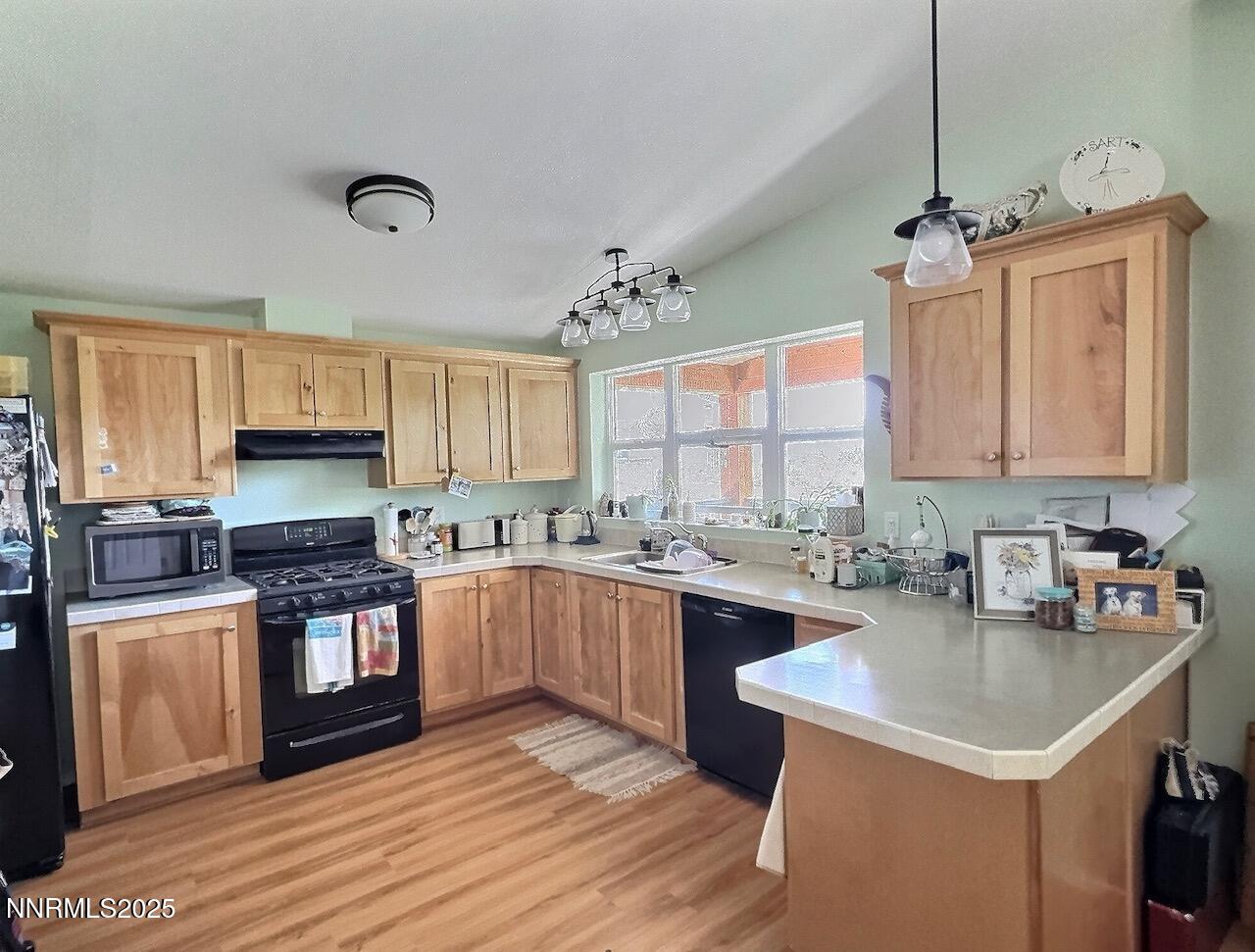 113 Victorine Drive Kingston, NV 89310 - Photo 13 of 44 a kitchen with stainless steel appliances granite countertop a sink stove and refrigerator