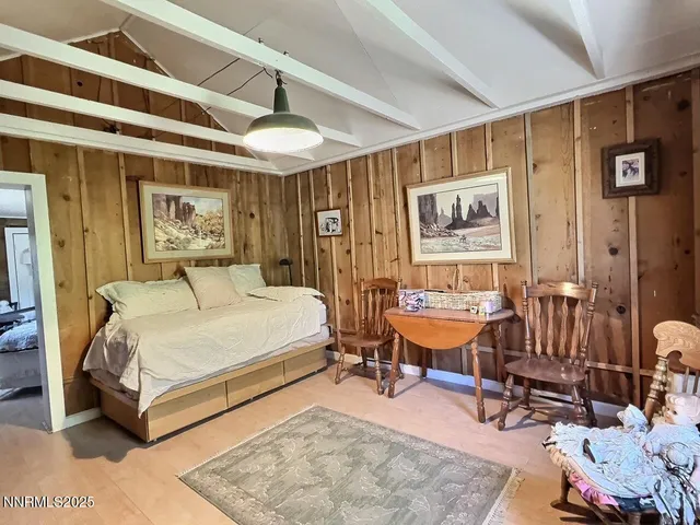 a bedroom with a bed a table and chair