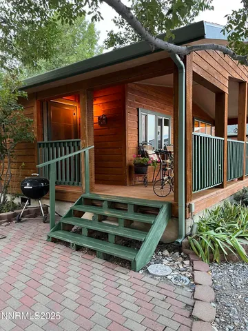 a view of backyard with deck and outdoor seating