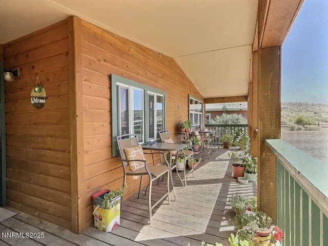 a balcony with chairs and wooden floor