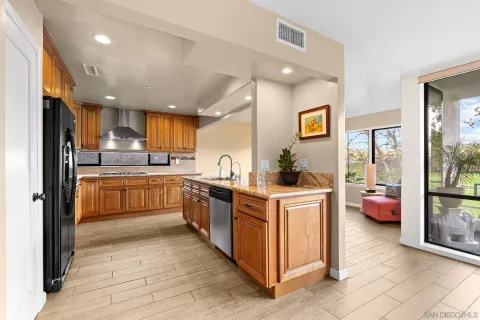 a kitchen with stainless steel appliances a stove a sink and a refrigerator