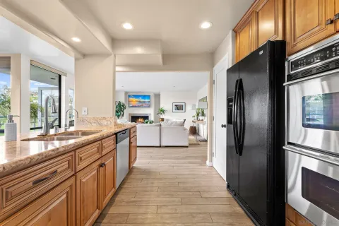 a kitchen with stainless steel appliances a refrigerator sink and cabinets