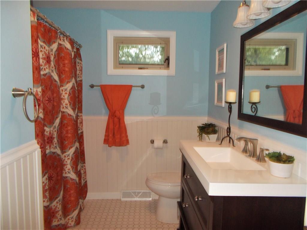 121 Mary Reed Road Baden, PA 15005 - Photo 14 of 24 Full bath. Main level. Newly remodeled with new tub, shower, toilet, sink, and vanity. Updated with new tile flooring, new lighting, and brushed nickel fixtures. A generous linen closet abuts.