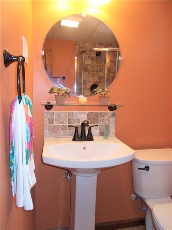 121 Mary Reed Road Baden, PA 15005 - Photo 17 of 24 Full Bath. Lower level. All new. Pedestal sink, updated lighting, ceramic tile flooring, oil-rubbed bronze fixtures. Notice the tiled walk-in shower in the mirror.