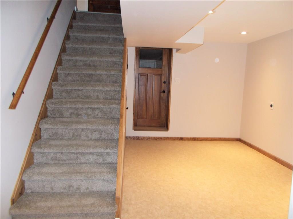 121 Mary Reed Road Baden, PA 15005 - Photo 21 of 24 Additional Room. Lower level. 9x13. Previously used as a lower-level kitchen. Adjacent to the family room, this space would be perfect for a game room or wet bar. Beyond the door is an area previously used as a laundry room.