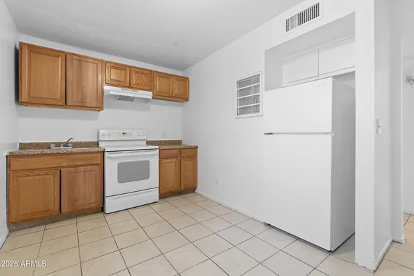 a utility room with sink dryer and washer