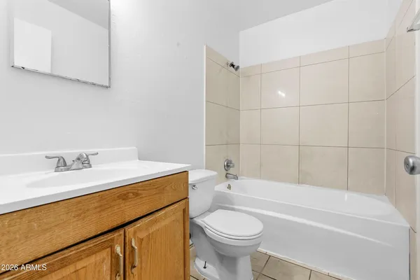 a bathroom with a sink a toilet and bathtub