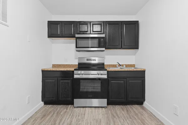 a kitchen with stainless steel appliances granite countertop a stove and a microwave