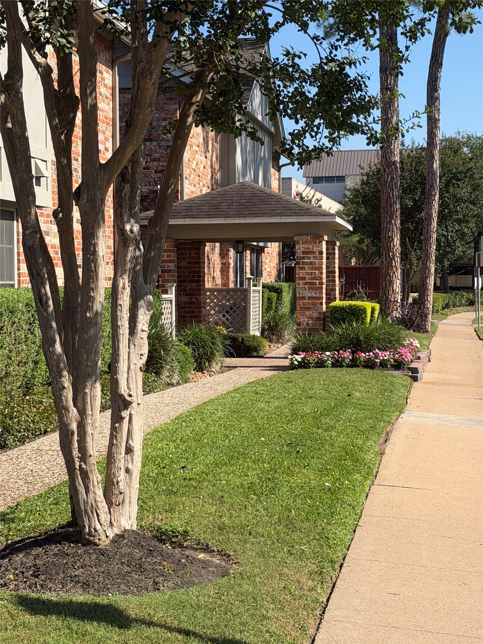 515 Tallowood Road, Unit 55 Houston, TX 77024 - Photo 4 of 18 a front view of a house with a yard