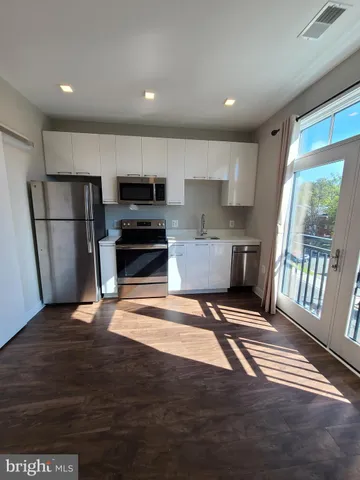 a view of a kitchen with seating area and barbeque oven
