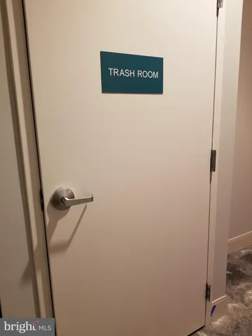 a view of a hallway with stairs and a door