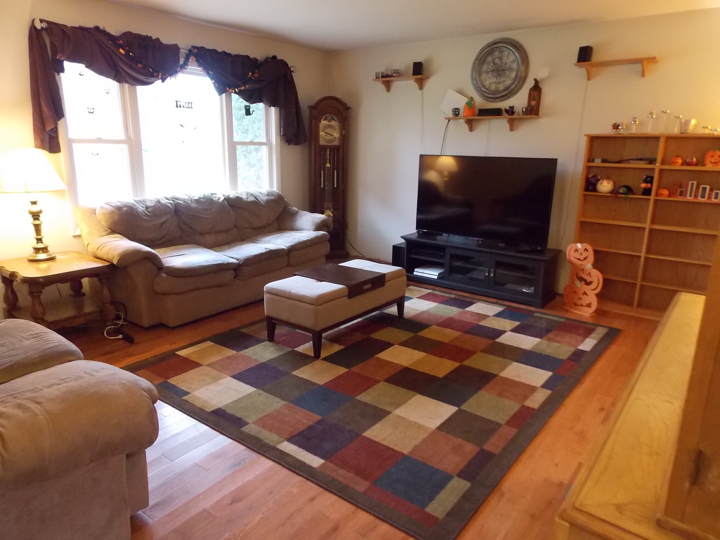 350 Orion Road Batavia, IL 60510 - Photo 3 of 13 a living room with furniture a flat screen tv and a fireplace