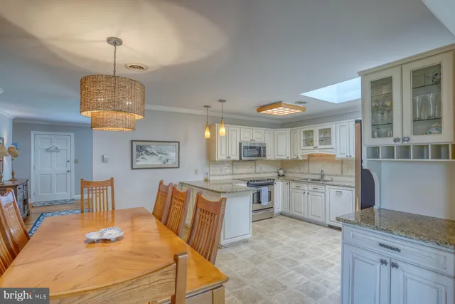 a living room with furniture a large window and a fireplace