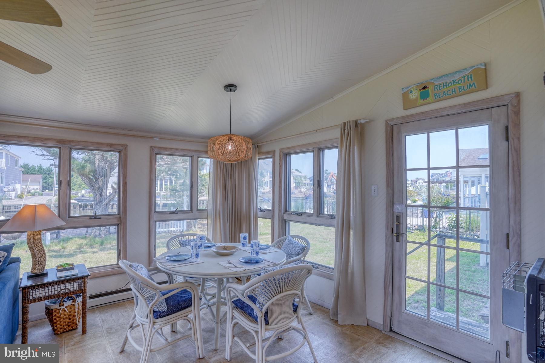 28 Marshall Road Rehoboth Beach, DE 19971 - Photo 18 of 60 a view of a dining room with furniture large windows and wooden floor