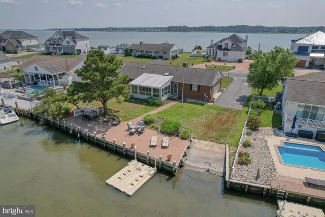 an aerial view of a house with a garden and lake view