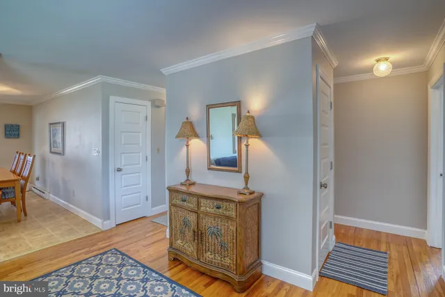 a view of a room with wooden floor and cabinet