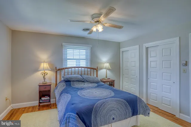 a bathroom with a granite countertop sink mirror and cabinets