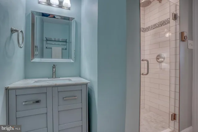 a bathroom with a granite countertop sink a toilet and a mirror