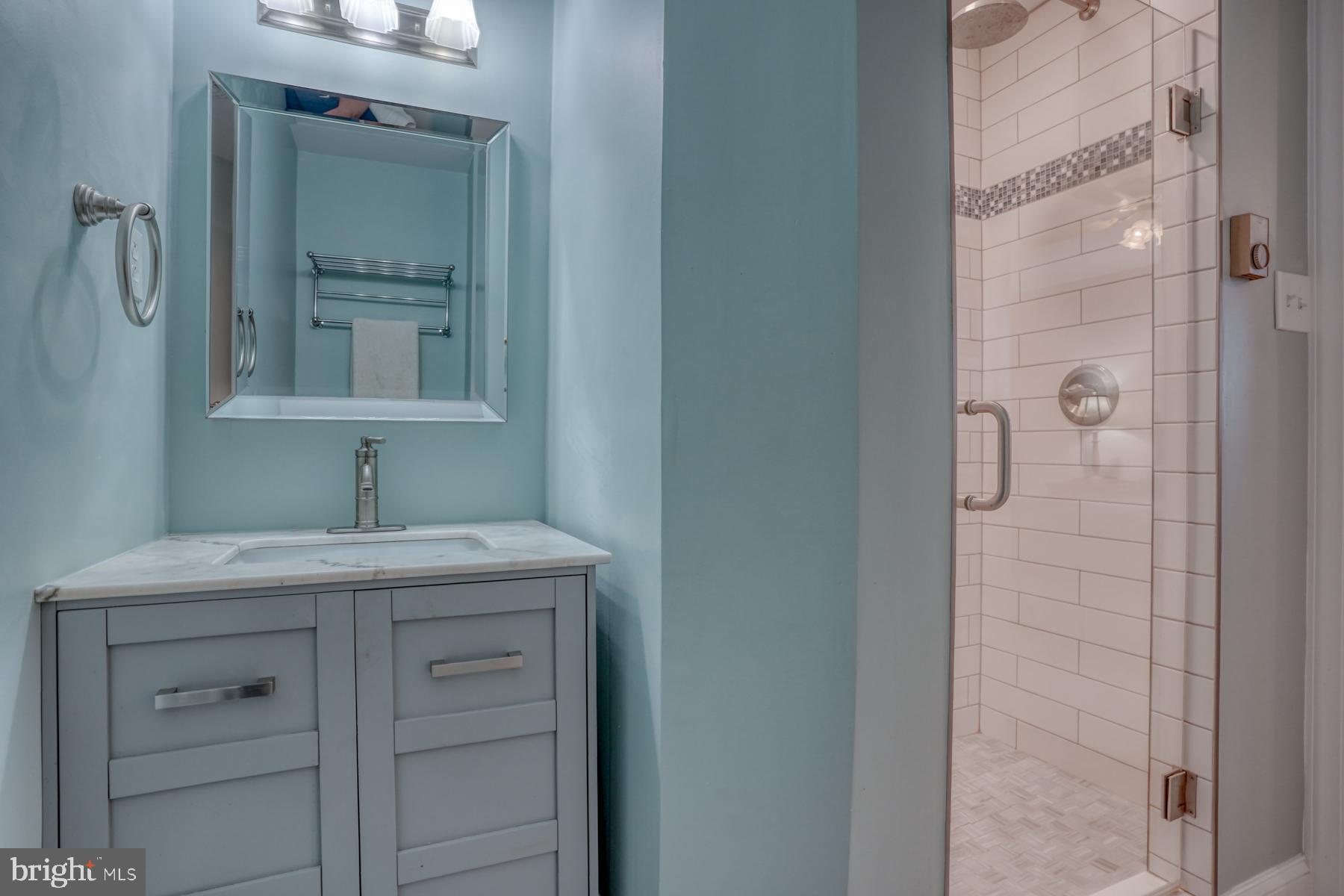 28 Marshall Road Rehoboth Beach, DE 19971 - Photo 32 of 60 a bathroom with a granite countertop sink mirror and cabinets