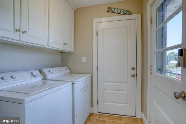 an aerial view of a house with a garden and lake view
