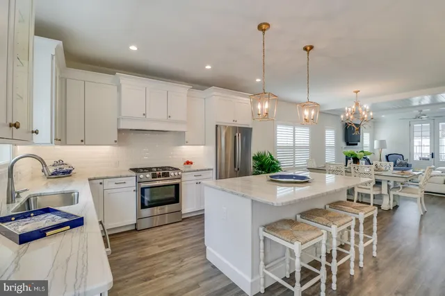 a dining room with wooden floor a glass table and chairs