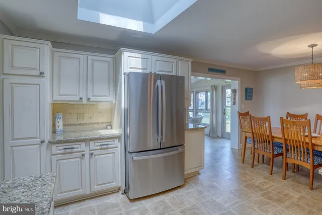 a kitchen with stainless steel appliances granite countertop a refrigerator and cabinets