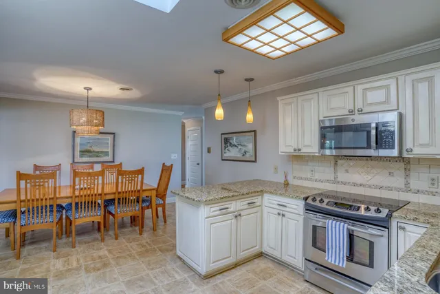 a kitchen with a stove a sink and a refrigerator