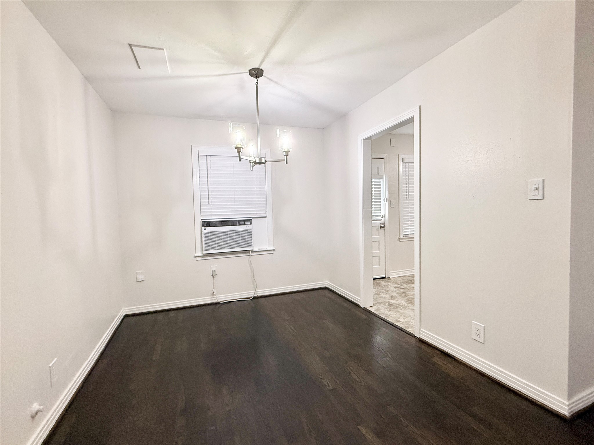 832 South Anderson Street Angleton, TX 77515 - Photo 6 of 19 an empty room with wooden floor cabinet and windows