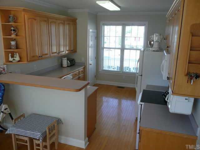 100 Crossfire Road Holly Springs, NC 27540 - Photo 6 of 11 Sunshiny Kitchen with Hardwood Floors