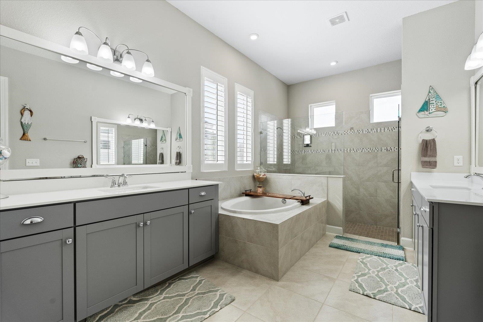 122 Kendall Way Street St. Augustine, FL 32092 - Photo 13 of 40 a spacious bathroom with a double vanity sink mirror and bathtub