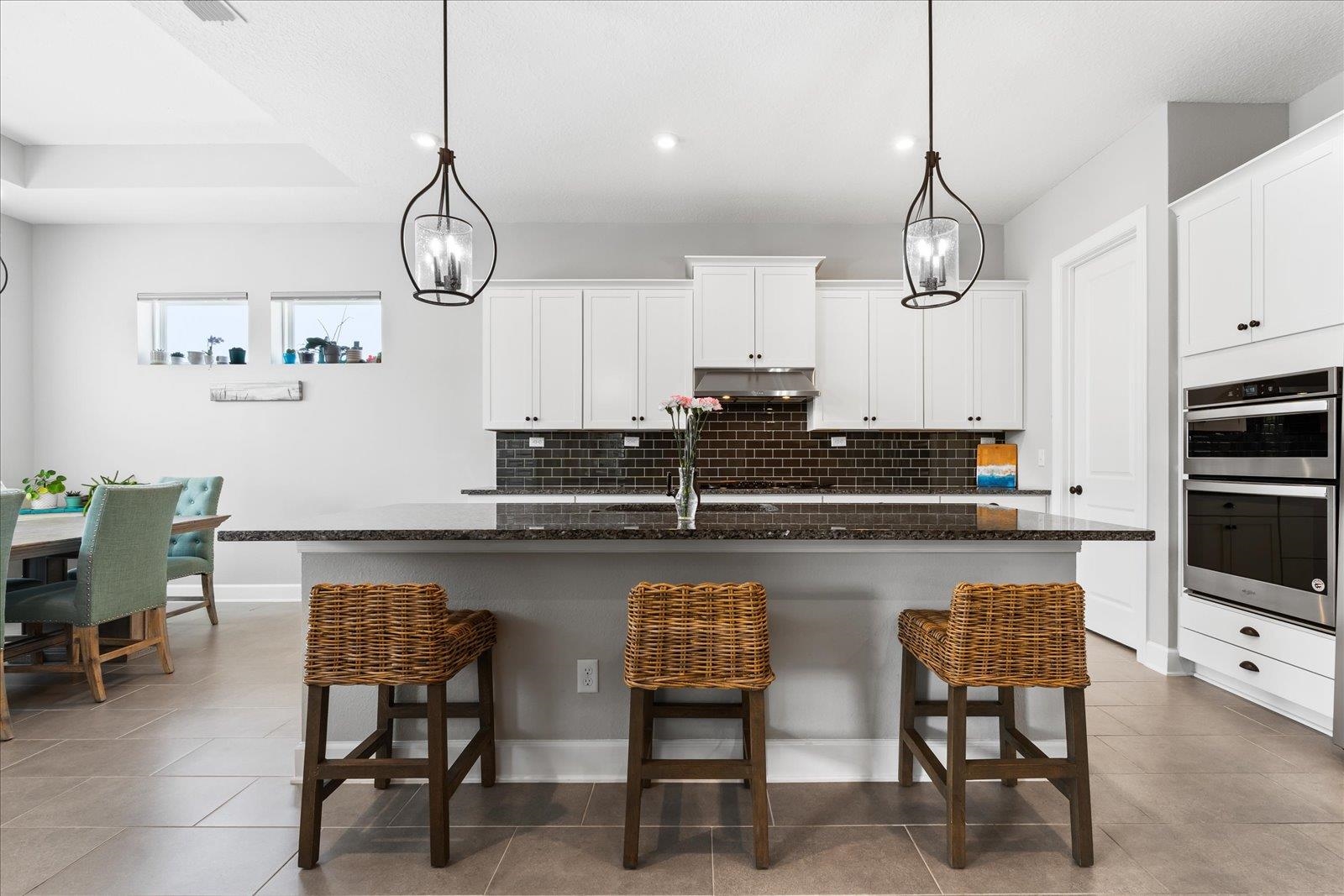 122 Kendall Way Street St. Augustine, FL 32092 - Photo 7 of 40 a kitchen with stainless steel appliances a table chairs refrigerator and microwave