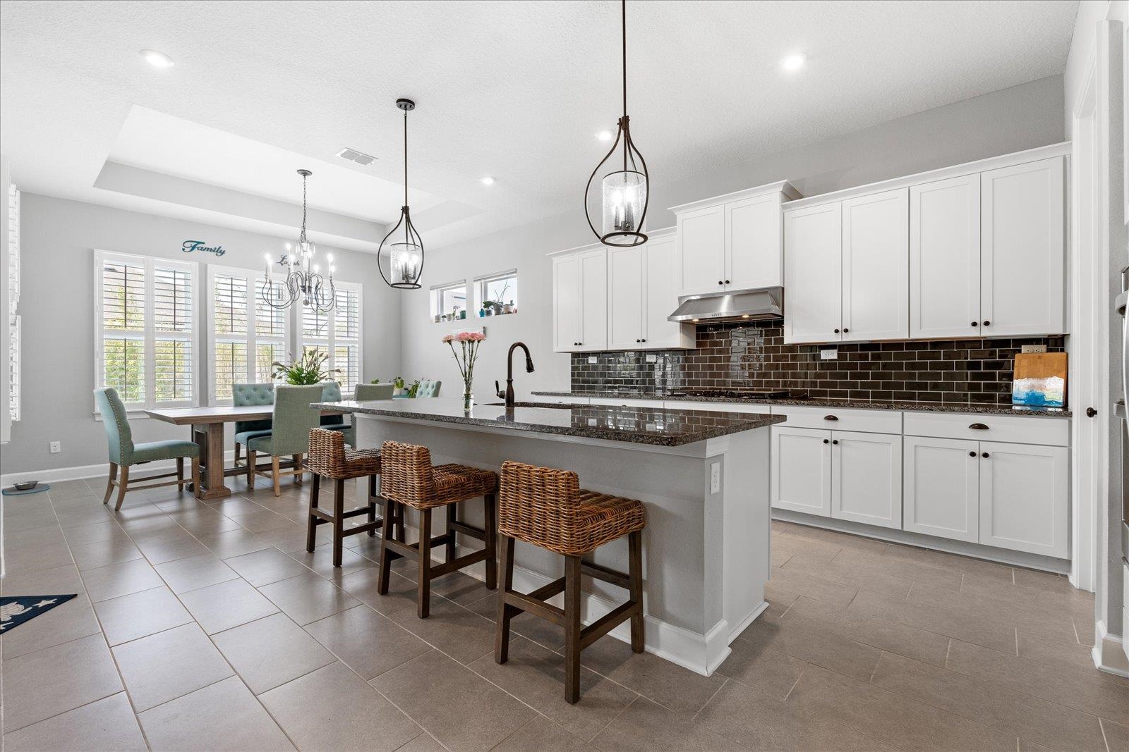 122 Kendall Way Street St. Augustine, FL 32092 - Photo 8 of 40 a kitchen with stainless steel appliances granite countertop a stove a sink and a refrigerator