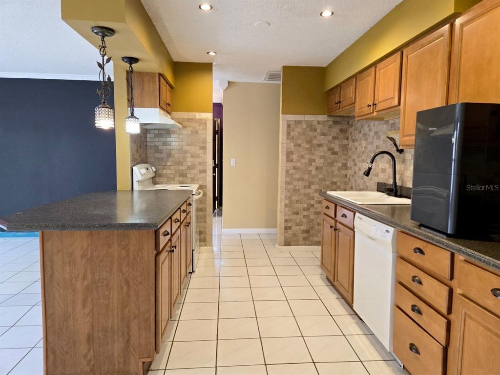 19 Spring Dr Place Ocala, FL 34472 - Photo 7 of 29 a kitchen with stainless steel appliances granite countertop a refrigerator a stove top oven and a sink with granite countertops